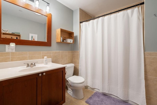 bathroom with tile walls, tile patterned flooring, vanity, toilet, and walk in shower