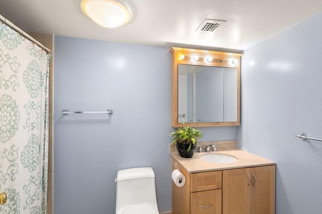 full bath featuring vanity and toilet