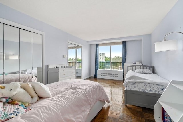bedroom with radiator and a closet