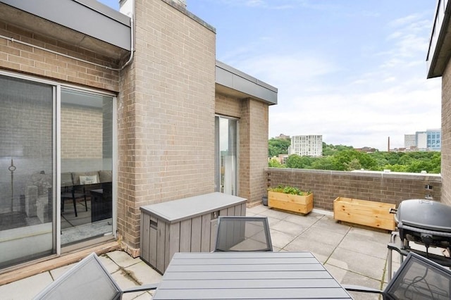 view of patio with outdoor dining area and area for grilling