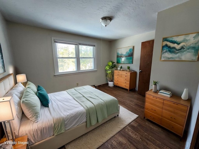 bedroom featuring dark wood finished floors