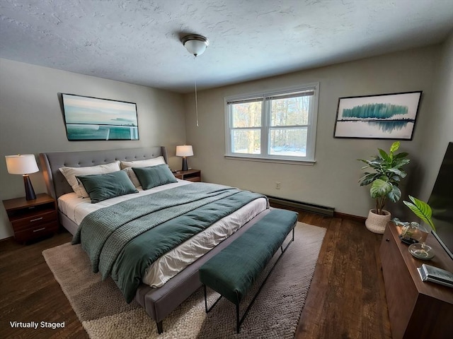 bedroom with dark wood-style floors, baseboard heating, a textured ceiling, and baseboards