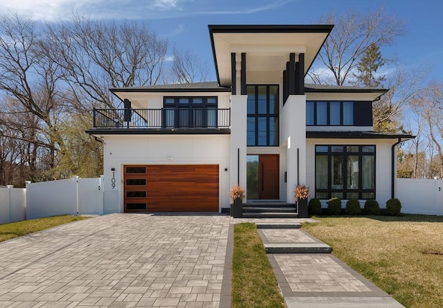 109 Wiswall Rd, Newton, MA 02459 - contemporary home featuring a balcony, stucco siding, decorative driveway, an attached garage, and a gate