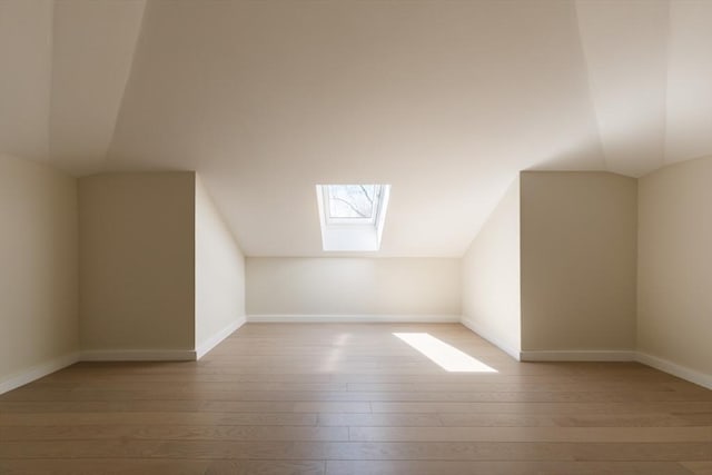 109 Wiswall Rd, Newton, MA 02459 - additional living space with a skylight, hardwood / wood-style flooring, lofted ceiling, and baseboards