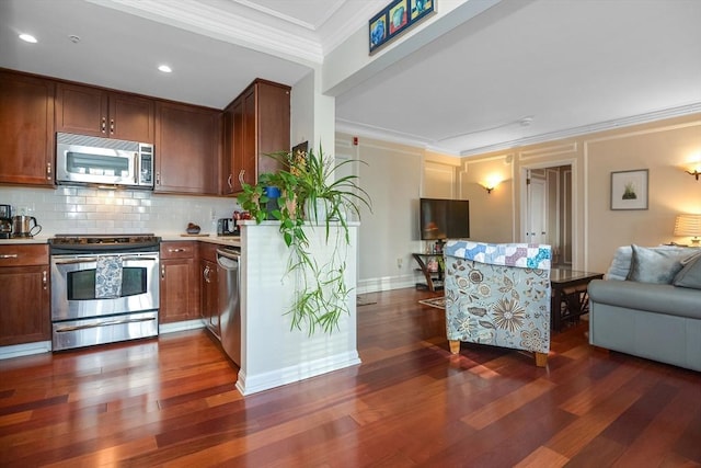 kitchen with dark wood finished floors, crown molding, light countertops, decorative backsplash, and appliances with stainless steel finishes