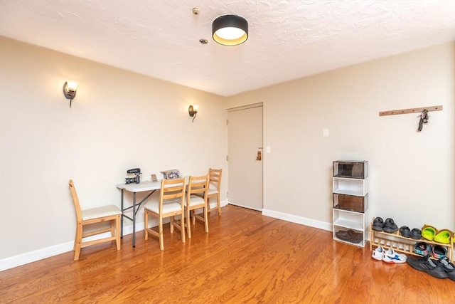 dining room with baseboards and wood finished floors