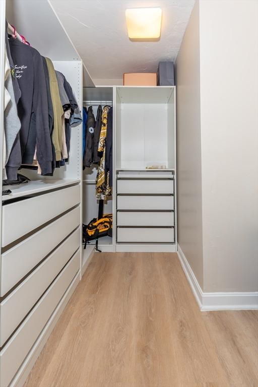 spacious closet featuring light wood-style floors