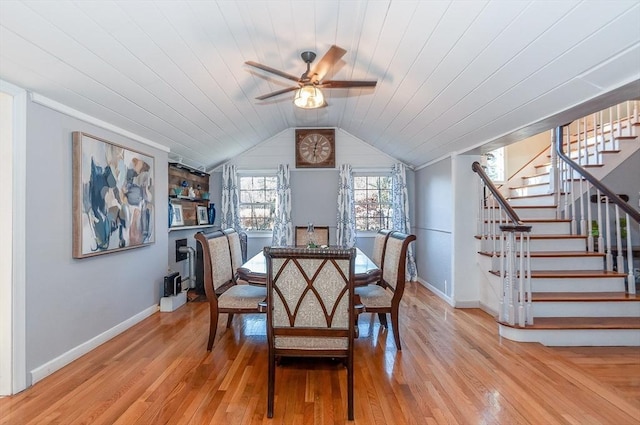 dining space with ceiling fan, wooden ceiling, and light wood-type flooring