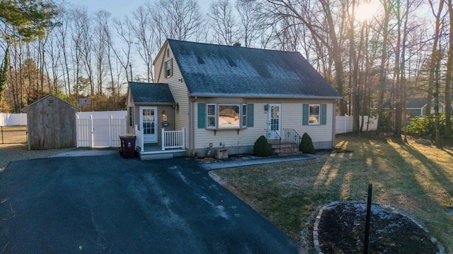 new england style home with a storage shed