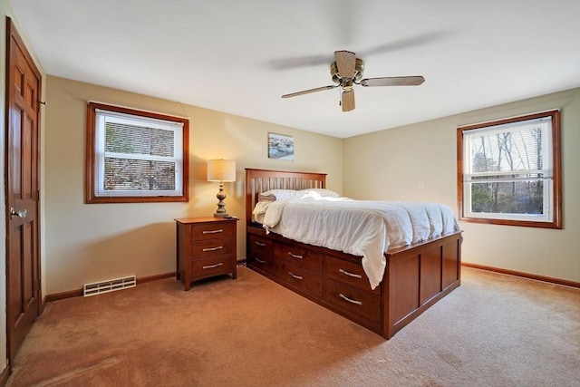 bedroom featuring ceiling fan and light carpet