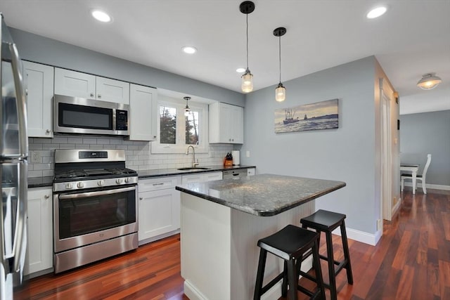 kitchen with sink, white cabinetry, a center island, and stainless steel appliances