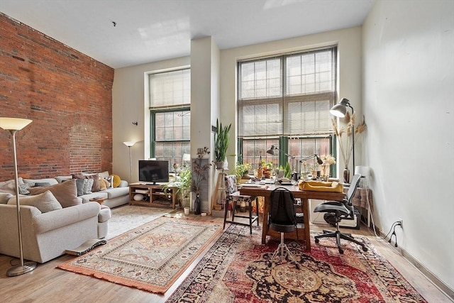 200 Market St Unit 44B, Lowell, MA 01852 - office area featuring wood finished floors, a high ceiling, and brick wall