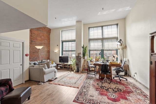 200 Market St Unit 44B, Lowell, MA 01852 - living area with light wood-style floors, healthy amount of natural light, and a desk