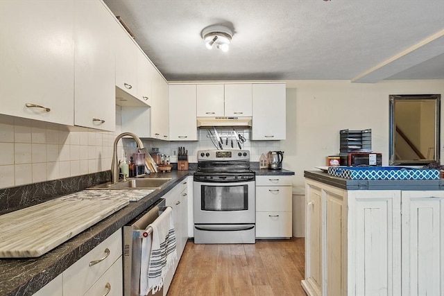 200 Market St Unit 44B, Lowell, MA 01852 - kitchen with appliances with stainless steel finishes, under cabinet range hood, a sink, dark countertops, and white cabinets