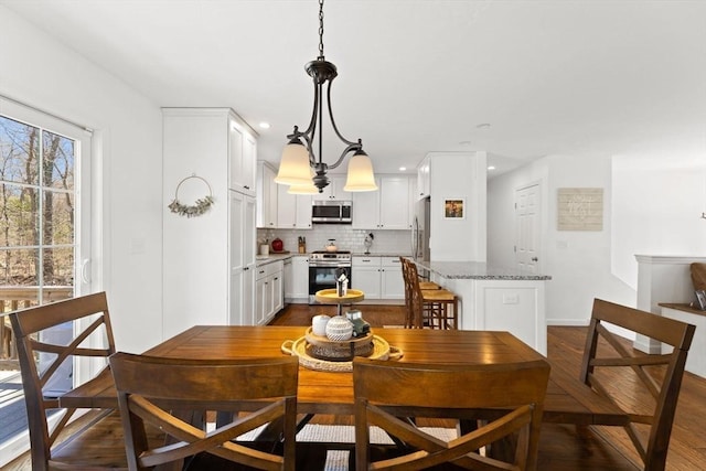 dining room featuring dark wood-style floors and recessed lighting