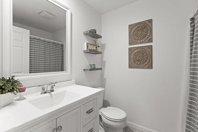 full bath with baseboards, vanity, and toilet