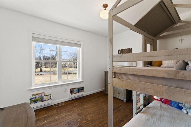 bedroom featuring visible vents, vaulted ceiling, baseboards, and wood finished floors