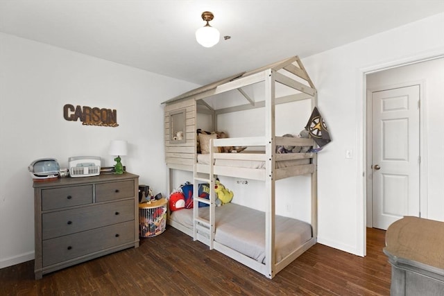 bedroom with baseboards and wood finished floors