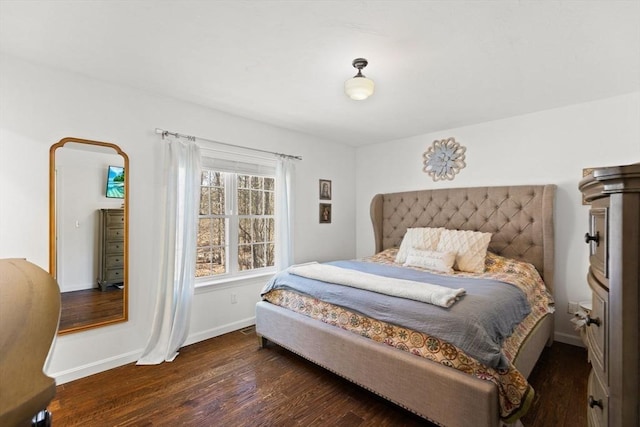 bedroom with wood finished floors and baseboards