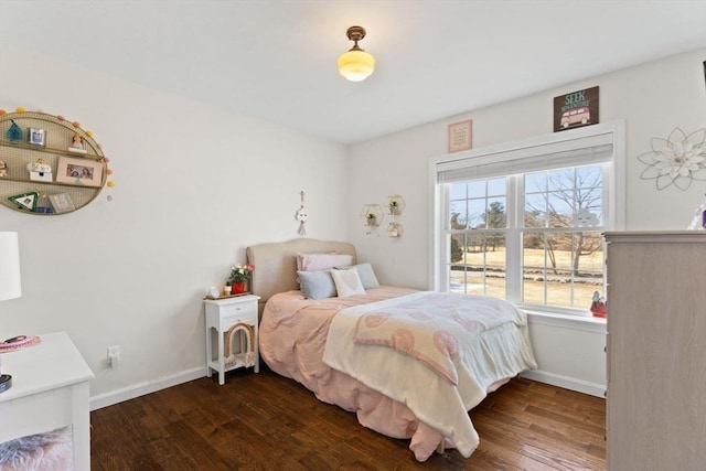 bedroom with baseboards and wood finished floors