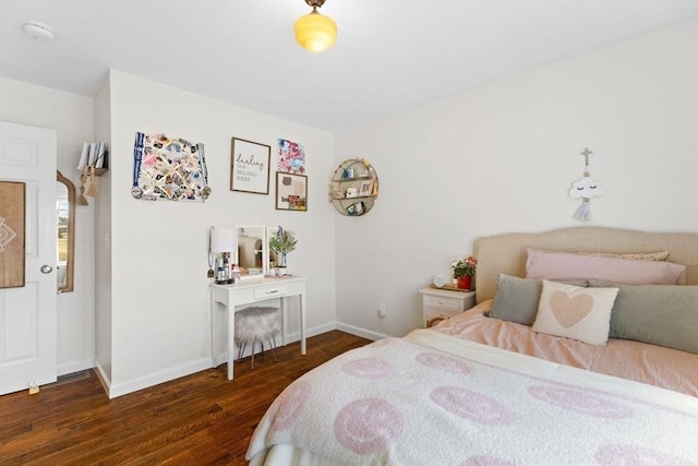 bedroom with wood finished floors and baseboards