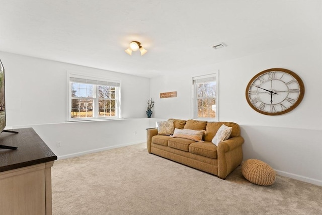 carpeted living room featuring baseboards and visible vents