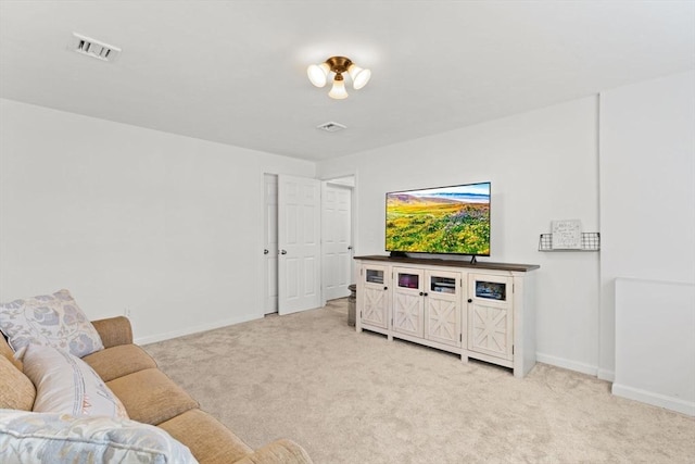 living room with light colored carpet, visible vents, and baseboards