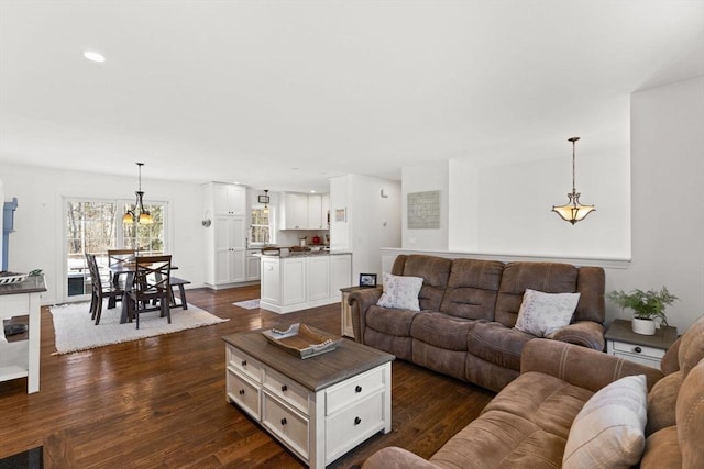 living area with dark wood-style floors and recessed lighting