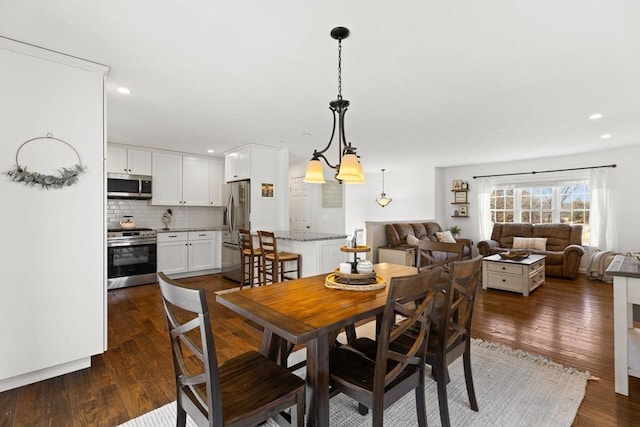 dining room with recessed lighting and dark wood finished floors