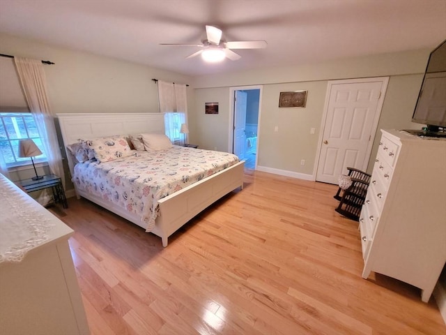 bedroom featuring baseboards, light wood-style flooring, and a ceiling fan