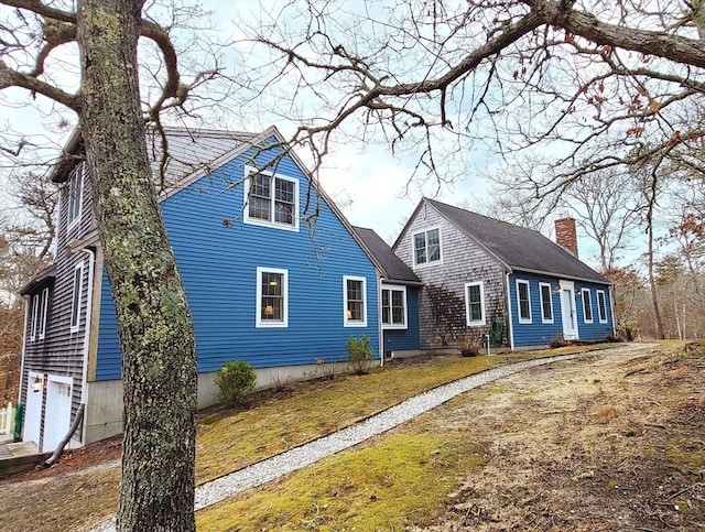 new england style home with a chimney