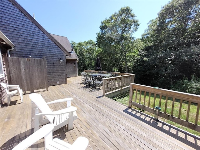 wooden terrace featuring outdoor dining area