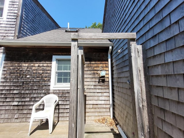 entrance to property with roof with shingles
