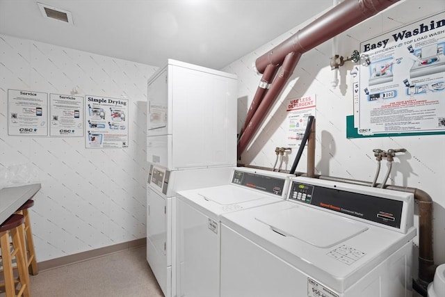 shared laundry area featuring visible vents, stacked washing maching and dryer, separate washer and dryer, baseboards, and wallpapered walls