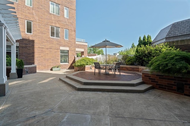 view of patio with fence and outdoor dining space