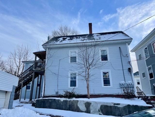 view of snow covered exterior featuring a garage