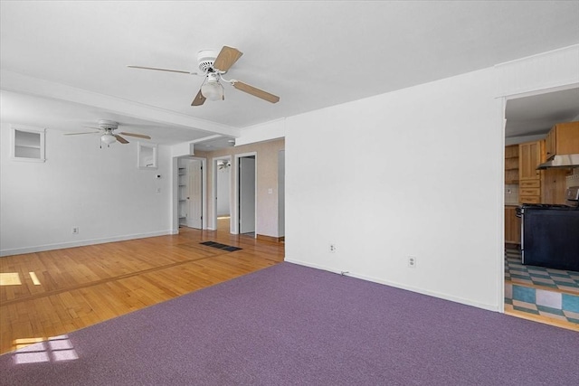 interior space with visible vents, baseboards, ceiling fan, and light colored carpet