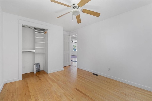 unfurnished bedroom featuring a ceiling fan, visible vents, baseboards, a closet, and light wood-style flooring