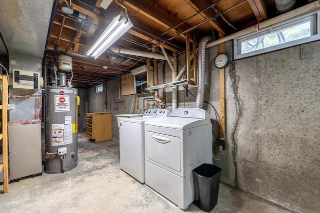 below grade area featuring washing machine and clothes dryer and gas water heater