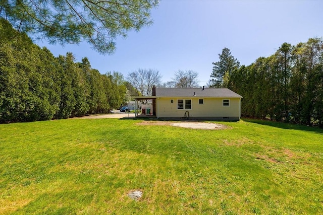 back of property with a yard and a patio area