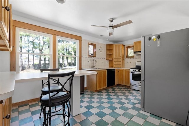 kitchen featuring open shelves, appliances with stainless steel finishes, a sink, and light floors