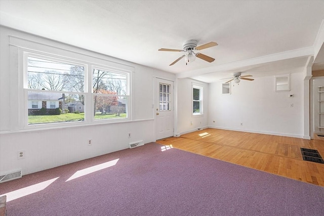 spare room with plenty of natural light, ceiling fan, and visible vents