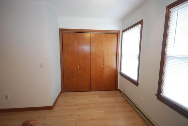 343 Chicopee St Unit 41, Chicopee, MA 01013 - unfurnished bedroom with multiple windows, light wood-style flooring, a closet, and baseboards