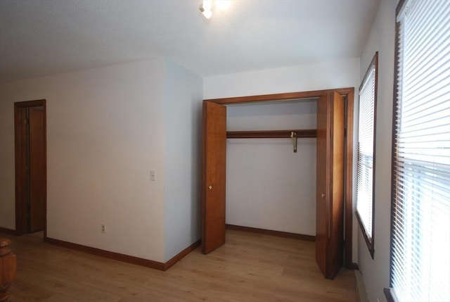 343 Chicopee St Unit 41, Chicopee, MA 01013 - unfurnished bedroom featuring light wood-style floors, a closet, and baseboards