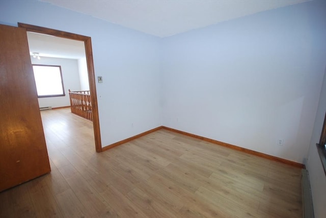 343 Chicopee St Unit 41, Chicopee, MA 01013 - spare room featuring light wood-style flooring, baseboards, a baseboard heating unit, and baseboard heating