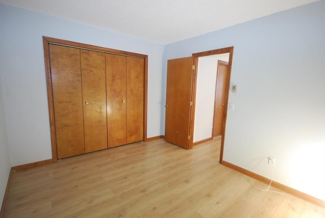 343 Chicopee St Unit 41, Chicopee, MA 01013 - unfurnished bedroom with light wood-style flooring, baseboards, and a closet