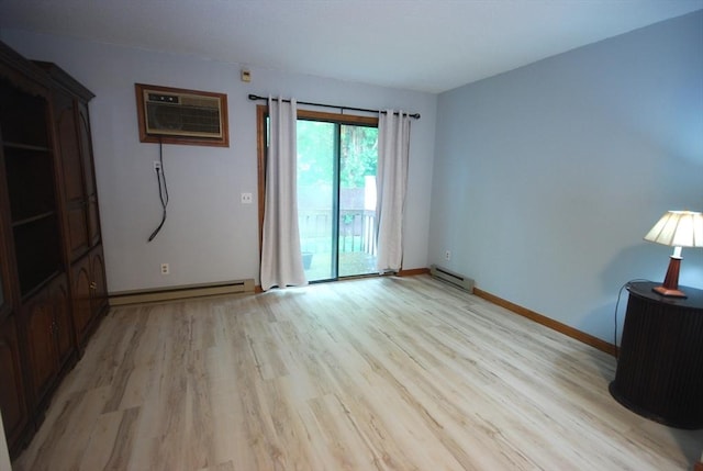 343 Chicopee St Unit 41, Chicopee, MA 01013 - spare room featuring a baseboard heating unit, light wood-type flooring, a wall unit AC, and baseboards