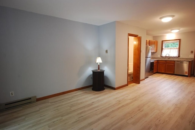 343 Chicopee St Unit 41, Chicopee, MA 01013 - kitchen with appliances with stainless steel finishes, a sink, light wood-style flooring, and a baseboard heating unit