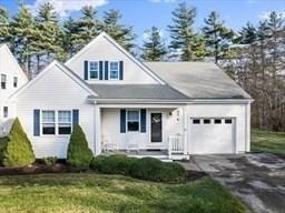 view of front of house with driveway, an attached garage, and a front yard