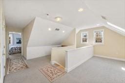 bonus room featuring lofted ceiling and carpet flooring